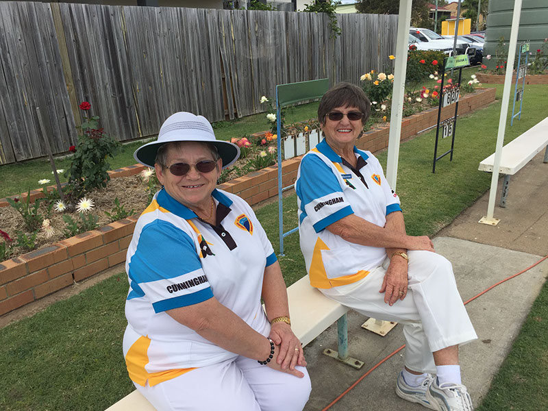 Club members beside the rose garden